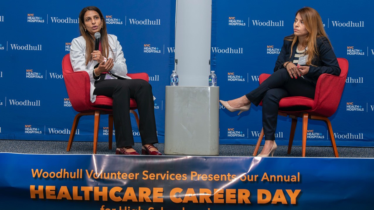 Two women sitting on a stage

AI-generated content may be incorrect.