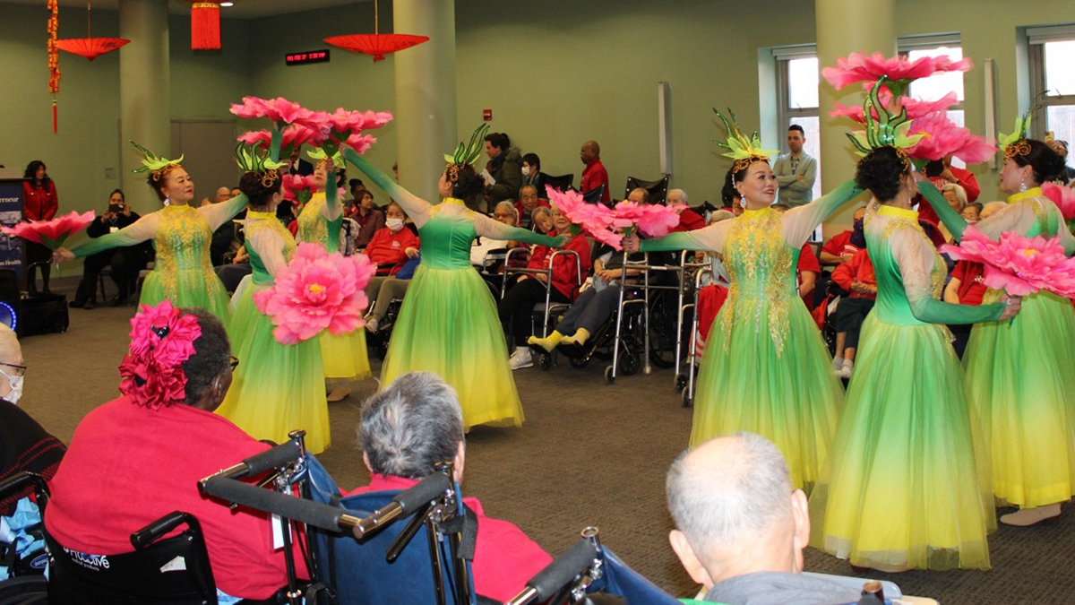 A group of women performing in a room
AI-generated content may be incorrect.