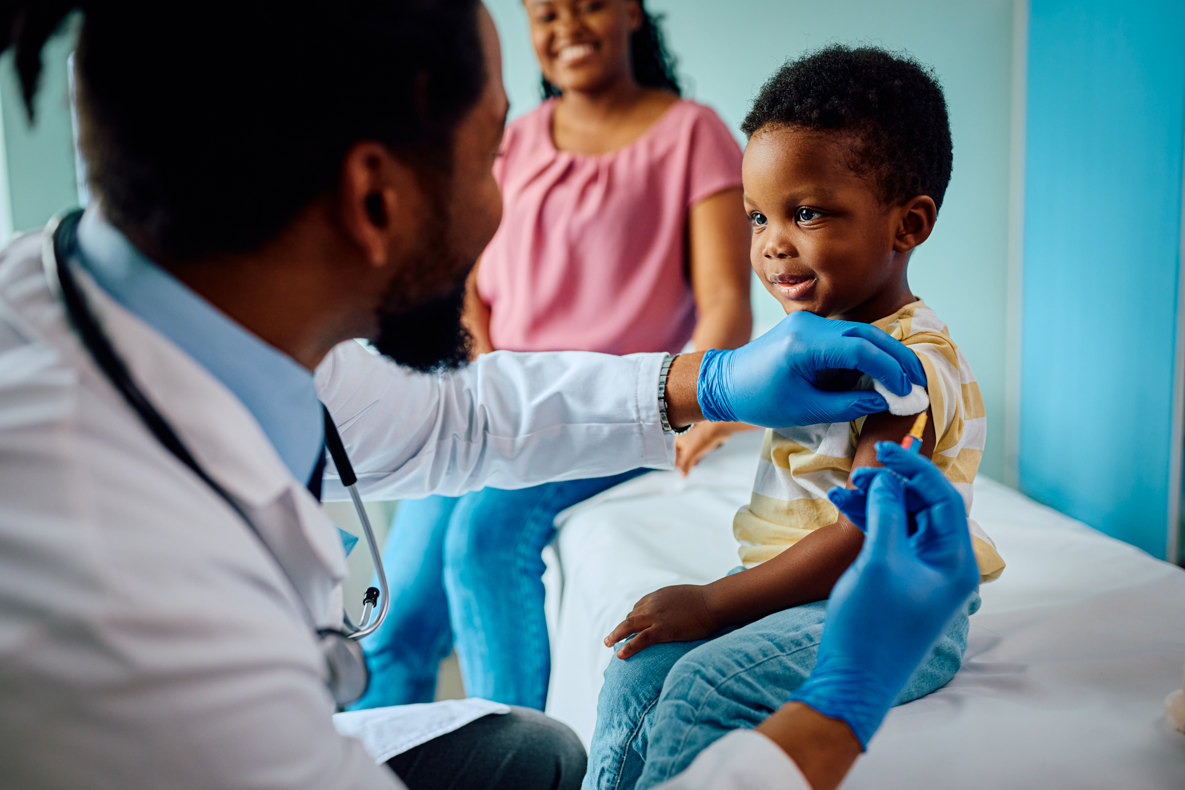 Doctor administrating vaccination to pediatric patient for a healthy school year.