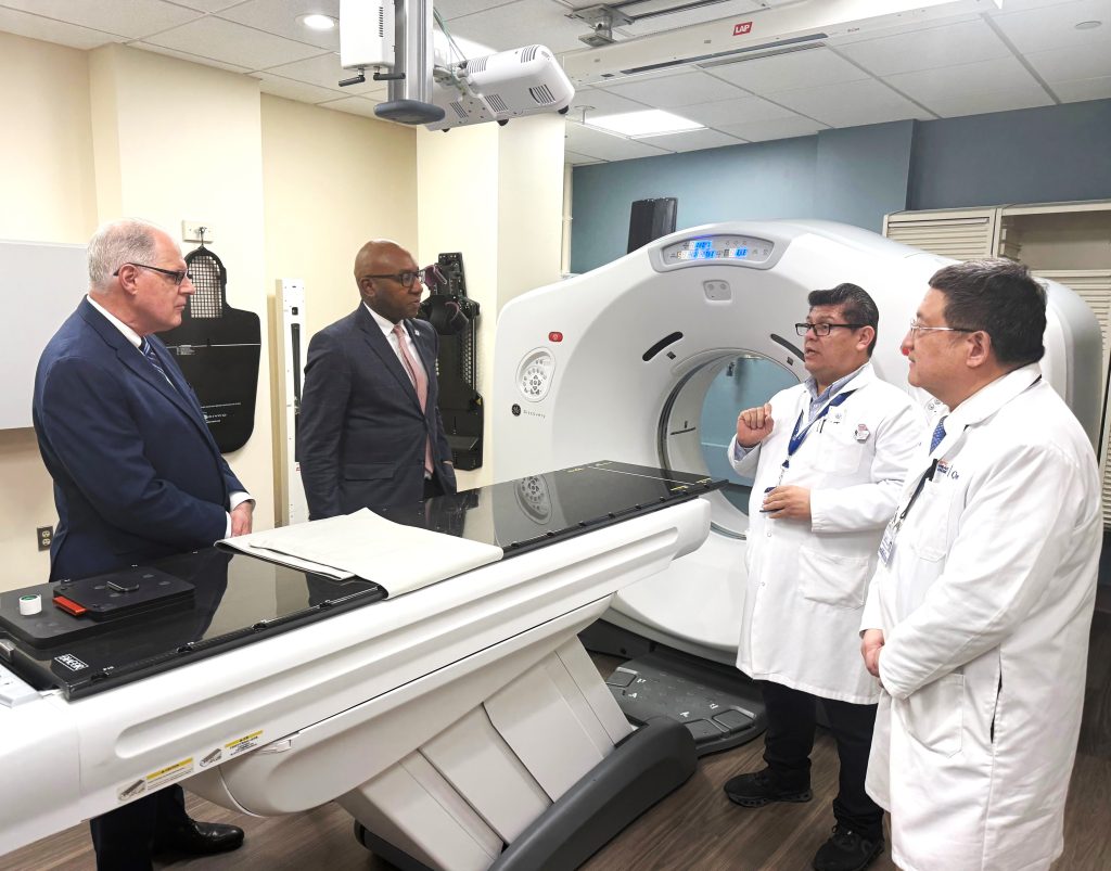 Tomas Saravia, lead therapist (2nd from right), discusses how the new TrueBeam linear accelerator will improve patient care with (from left to right) City Council Member Jim Gennaro and Queens Borough President Donovan Richards — who provided $5 million in funding — as the hospital’s Chief of Radiation Therapy, Dr. William Lee, looks on (far right).