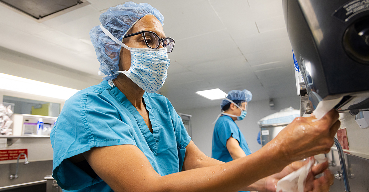 Not a regular hand wash. Dr. McLaurin and the surgical team prep for surgery by completing a prescribed handwashing and donning appropriate personal protective equipment (PPE). (2/3)