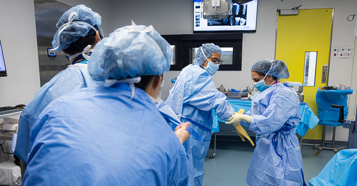 Not a regular hand wash. Dr. McLaurin and the surgical team prep for surgery by completing a prescribed handwashing and donning appropriate personal protective equipment (PPE). (3/3)
