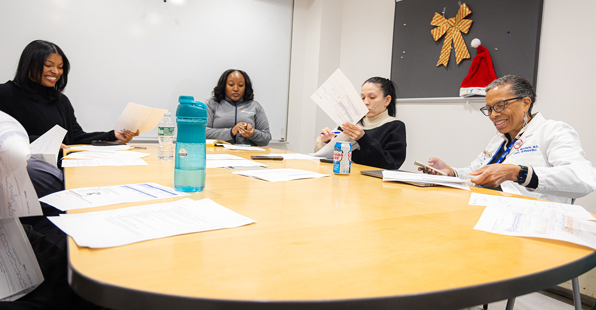 As Chief of Orthopedics at Bellevue Hospital, Dr. McLaurin meets with staff to discuss the clinic day ahead.