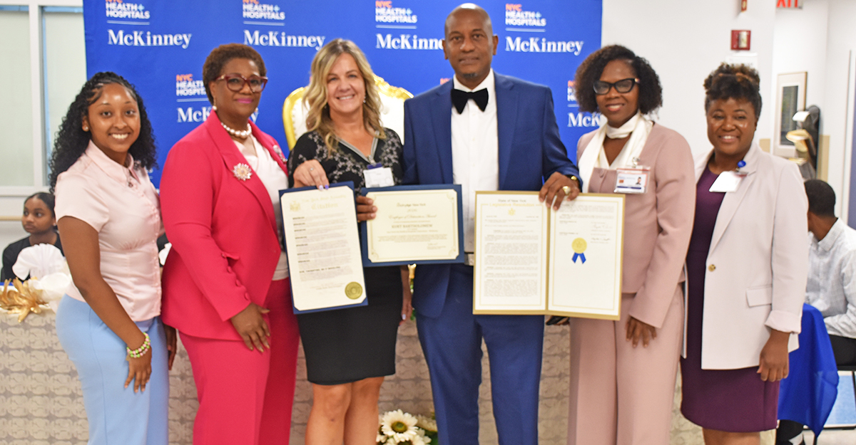 NYC Health + Hospitals/McKinney Executive Leadership and others join LeadingAge New York Senior Director of ProCare and Education Analyst Carrie Mosley to present a resolution from the New York State Legislature recognizing Kurt Bartholomew.