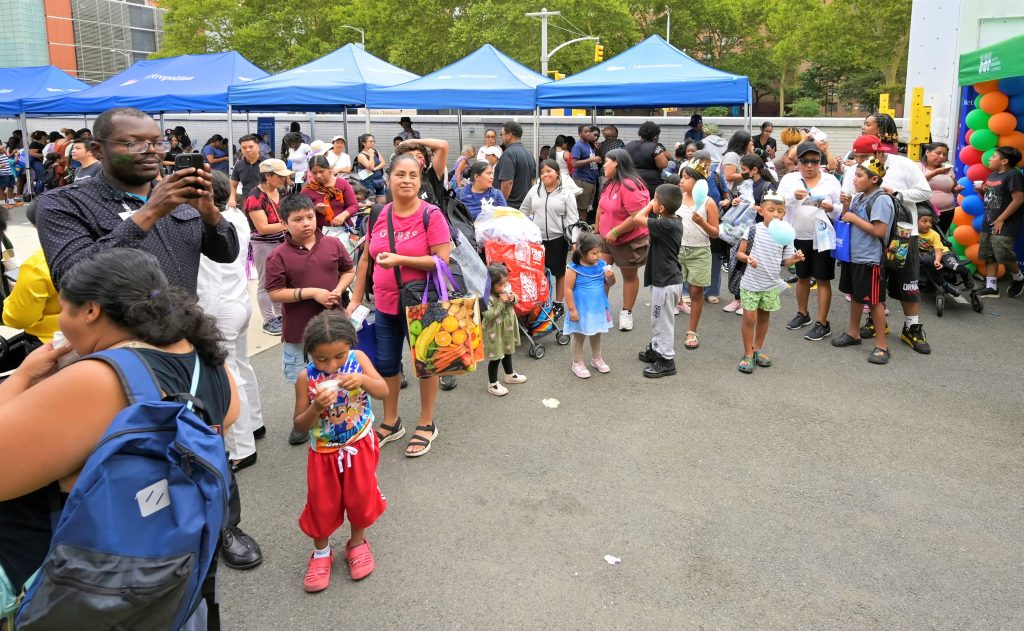Families and children gather at NYC Health + Hospitals/Metropolitan’s annual Back-to-School Fair, where students received backpacks, school supplies and bicycle helmets to prepare for the new school year.