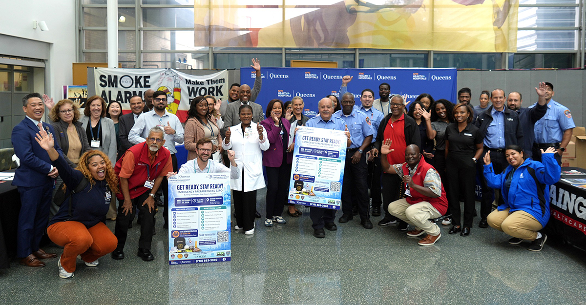 Hospital representatives from various departments at NYC Health + Hospitals/Queens gather for a group photo alongside external partners at the Emergency Preparedness Expo. This collaborative effort highlights the commitment of multiple organizations to enhance community resilience and preparedness through education and resource sharing.