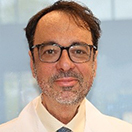 A person in a white coat
Description automatically generated