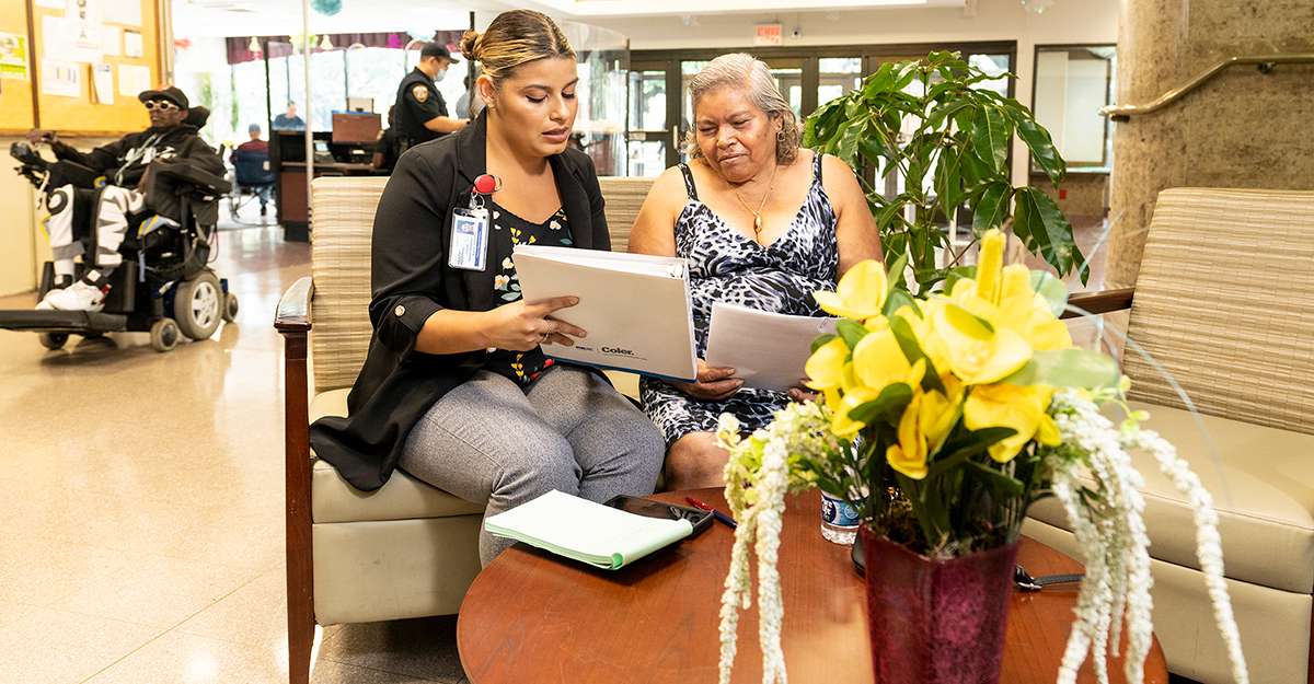 NYC Health + Hospitals/Coler patient relations team meets with a Family Care Partner to discuss resident participation in upcoming activities and programs to help improve social engagement. (Credit: John Rae)