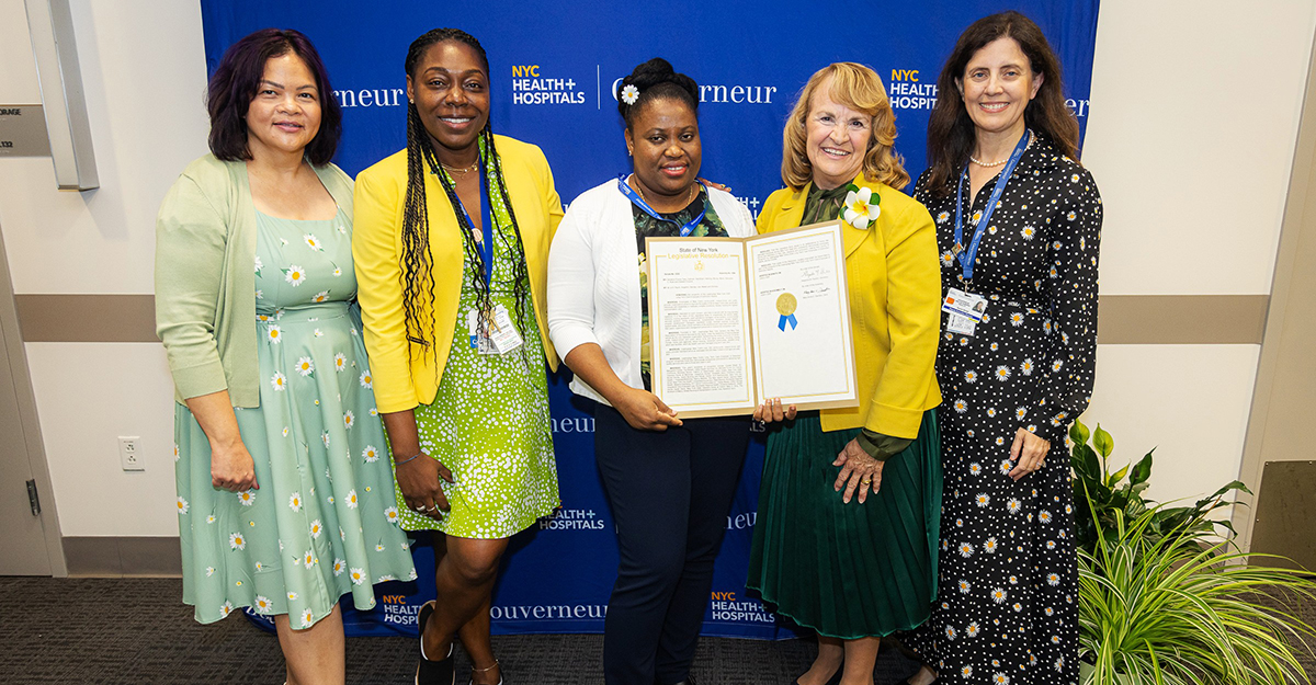 NYC Health + Hospitals/Gouverneur Executive Leadership and others present the LeadingAge New York Employee of Distinction Award with a resolution from the New York State Legislature recognizing Jasmine Slater Small.
