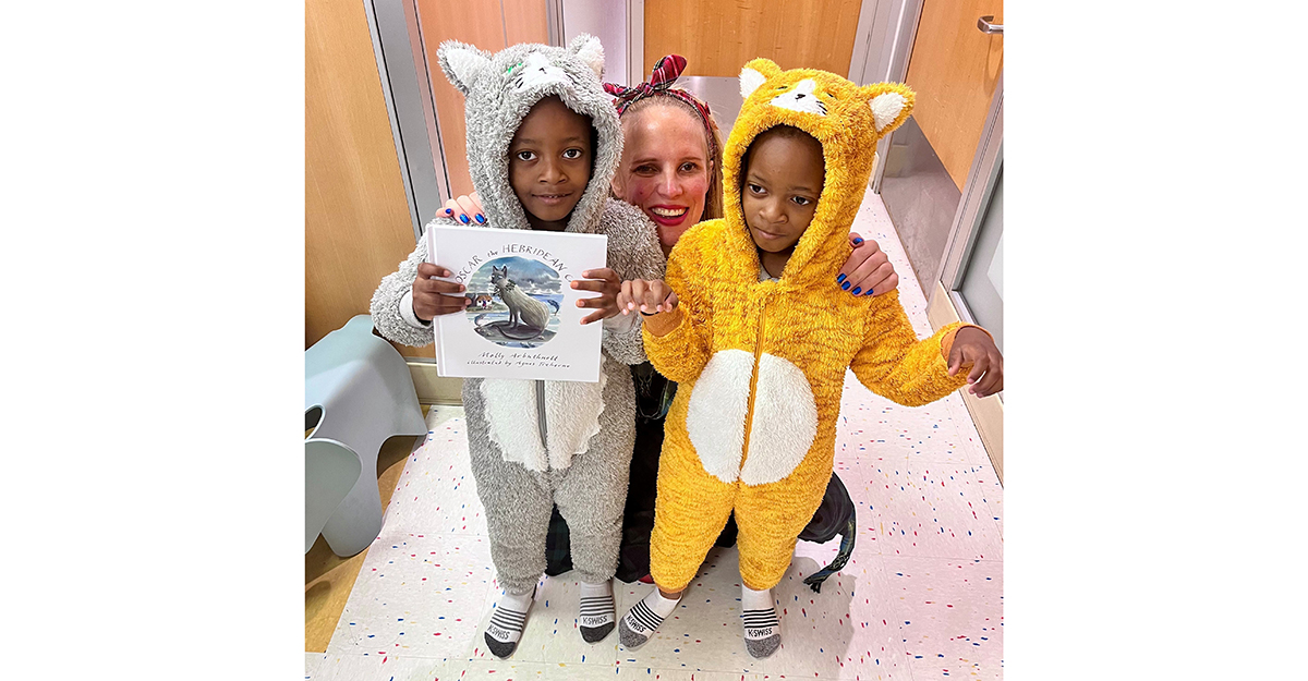 Author Molly Arbuthnott celebrates the pre-launch of her new book, Oscar the Hebridean Cat, with young fans dressed as the story’s characters during a special literacy event at NYC Health + Hospitals/Queens.