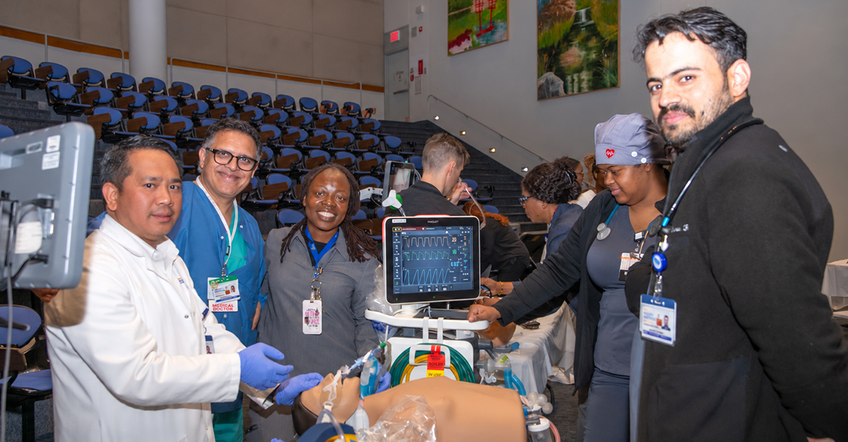 NYC Health + Hospitals/Woodhull staff participate in hands-on simulation training designed to strengthen teamwork, clinical readiness, and patient safety. From left: Brian Eclarinal, Director of Quality Management; Muhammad Iqbal, MD; Cynthia Cummings, Associate Respiratory Therapist; Ayanna Antoine, Associate Respiratory Therapist; and Masroor Rehman, Associate Respiratory Therapist. Photo by Julissa Herrera.