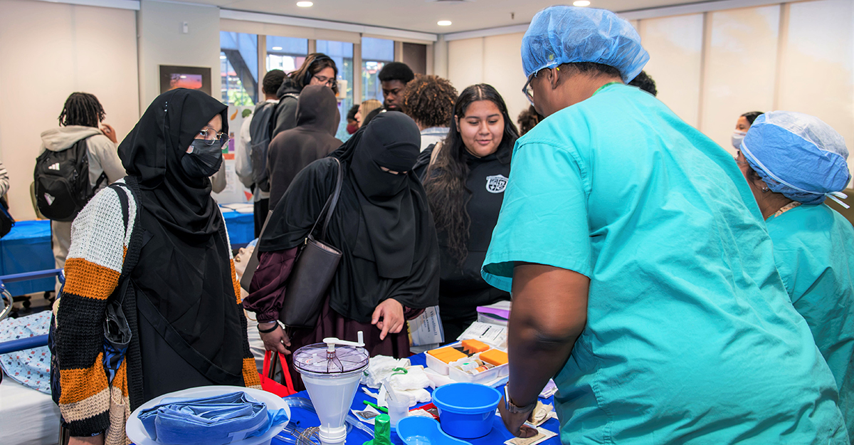 Students engage with members of the NYC Health + Hospitals/Woodhull clinical team during the Third Annual Healthcare Career Day, gaining hands-on exposure to healthcare careers, clinical tools, and the many roles that support patient care. Photo by Samuel Rodriguez.